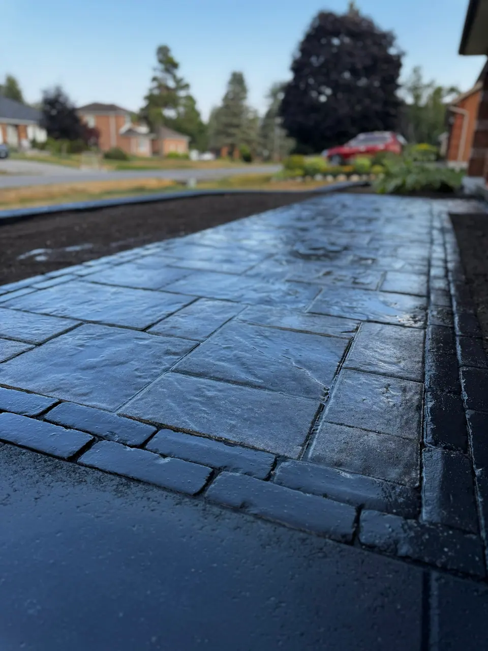 Close view of a paver walkway with a soldier-course border at a home in Midhurst, ON